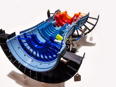 Colorful 3D-printed cutaway model of a jet engine showing internal turbine components.